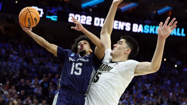 St. Peter's Peacocks guard Matthew Lee (15) shoots against Purdue Boilermakers center Zach Edey (15) in the second half in the semifinals of the East regional of the men's college basketball NCAA Tournament at Wells Fargo Center.